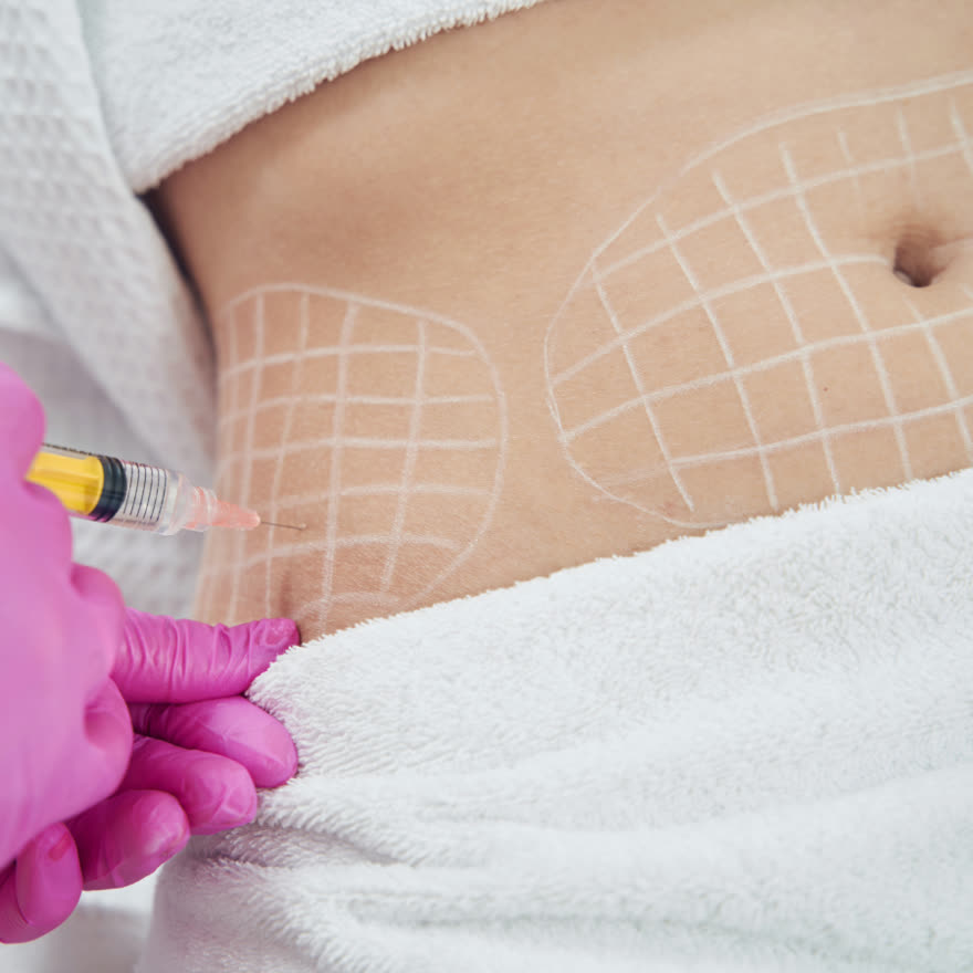 Practitioner administering a treatment to a mapped abdominal area